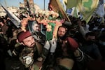 Fighters carry the coffin of Abu Baqir al-Saadi during his funeral on Feb. 8. He was a senior commander in Kataib Hezbollah, an Iran-backed Iraqi militia, who was killed in a U.S. drone strike in Baghdad.