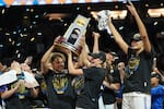 UCLA players celebrate after defeating South Carolina in the women's National Championship Final Four NCAA college basketball tournament game, Sunday, April 5, 2026, in Phoenix.