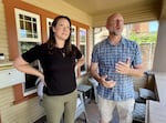 Kate Huckert and her boyfriend Mike Servant on the porch of her home, which is across the street from the city's newest homeless camp.