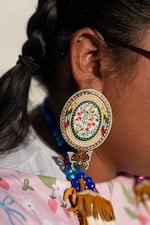 Ike-Andrews wears beaded earrings. “I just love the detail about it and the butterfly on it, and then the gold color on it. I'm a gold girly,” she says.