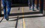 FILE - Staff members walk in an outdoor plaza at the Oregon State Hospital in Salem, March 8, 2023.