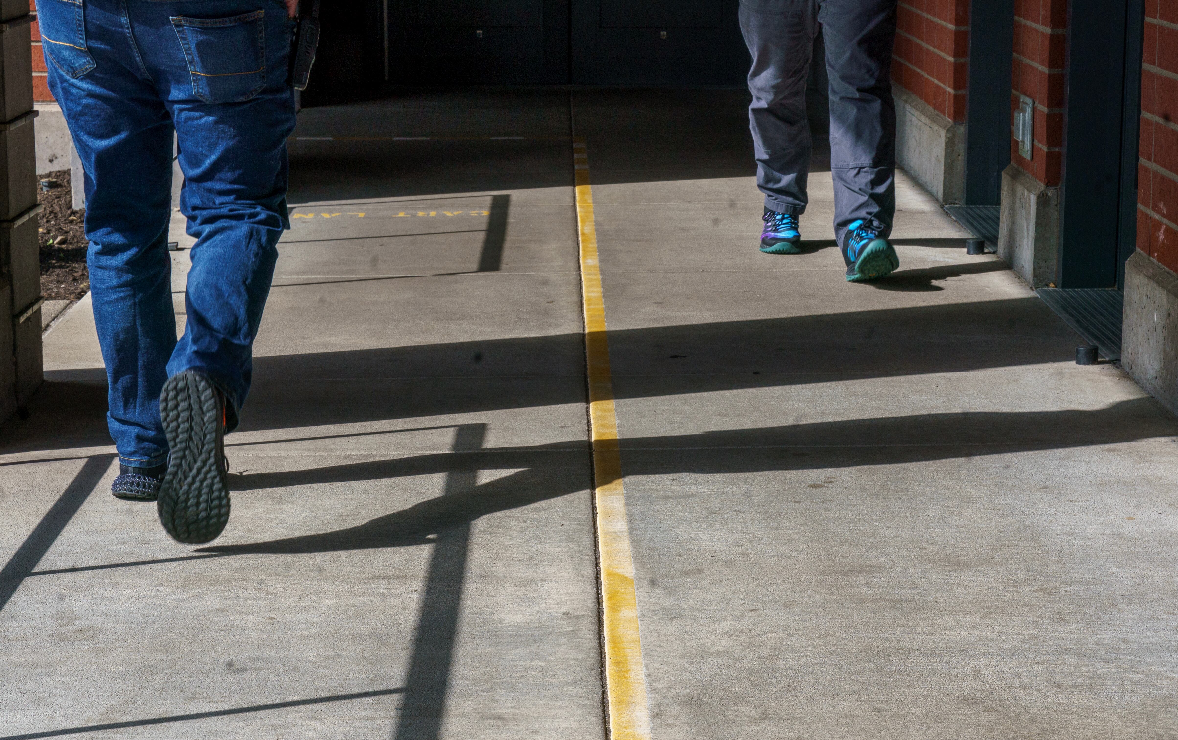 FILE - Staff members walk in an outdoor plaza at the Oregon State Hospital in Salem, March 8, 2023.
