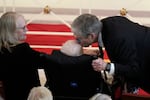 James "Chip" Carter kisses his father, former President Jimmy Carter, after speaking during a tribute service for his mother, former first lady Rosalynn Carter, at Glenn Memorial Church at Emory University on Tuesday, Nov. 28, 2023, in Atlanta, as Amy Carter, left, looks on.