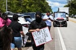 Protesters gather to demand the closure of the immigrant detention center known as "Alligator Alcatraz" at the Dade-Collier Training and Transition Airport in Ochopee, Fla., on July 22. Immigrants held at U.S. detention centers have experienced abusive and degrading treatment, a Human Rights Watch report said on July 21. 