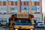 A school bus outside a school building.