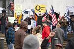 A follower of the fringe conspiracy theory group QAnon stands in front of the Oregon state Capitol during a rally to reopen Oregon in Salem on Saturday, May 2, 2020. 