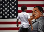 A young boy walks past a painting depicting Dr. Martin Luther King Jr. during a Juneteenth celebration in Los Angeles in 2020. Juneteenth marks the day in 1865 when federal troops arrived in Galveston, Texas, to take control of the state and ensure all enslaved people be freed, more than two years after the Emancipation Proclamation.