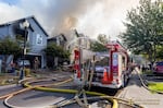 In this image provided by Portland Fire & Rescue, teams work at the scene where a small aircraft crashed into multiple townhouses in Fairview, Ore., August 31, 2024, killing three people.