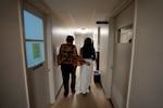A 33-year-old mother of three from central Texas is escorted down the hall by a clinic administrator prior to getting an abortion, at Hope Medical Group for Women in Shreveport, La., in late 2021. More than a dozen patients, mostly from Texas, arrived at the abortion clinic in Louisiana.
