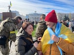 Hanna Malyar, Ukraine's deputy defense minister (center), signs a Ukrainian flag belonging to a local resident in Kherson on Monday. "Ukraine's success depends on two points," Malyar told NPR. "First our strength, our ability to fight. And second, the weapons that we receive from our partners," referring to the United States and other Western nations.