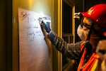 A volunteer writes down time entered and injured persons found in one building. The Neighborhood Emergency Teams program provides volunteers with training to help their neighbors in disaster situations.