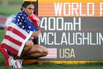 Gold medalist Sydney McLaughlin of the United States poses by a sign after winning the final of the women's 400-meter hurdles at the World Athletics Championships on Friday.