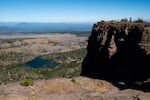 Hikers stand atop Tam McArthur Rim outside Bend, Ore., Friday, Sept. 24, 2021.