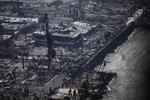 August 10: An aerial view shows destroyed homes and buildings that burned to the ground around the harbor and Front Street in the historic Lahaina Town.