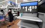 People shop at a Walmart in California in late 2021, with a few empty shelves amid the global supply-chain crisis.