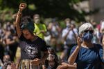 An attendee holds her fist in the air during Rev. E.D. Mondaine’s speech at the NAACP’s Eulogy for Black America held in the wake of the police killing of George Floyd on May 29, 2019, in Portland, Oregon.