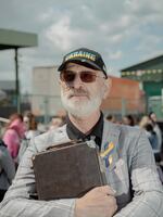 Yuri Vasylevych, 71, waits with his saxophone at the Poland-Ukraine border to cross to the Ukrainian side.