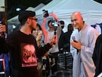 With his shaved head and flowing monk robe, a South Korean DJ chants traditional Buddhist scripture mixed with Generation Z life advice over a thumping electronic music beat, as the crowd goes wild on May 12.