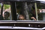 Britain's Camilla, Queen Consort (R), Britain's Catherine, Princess of Wales (2nd L), Britain's Prince George of Wales (L) and Britain's Princess Charlotte of Wales (2nd R) travel down The Mall in London.