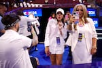 Social media influencers wearing white produce content during the final day of the Democratic National Convention in Chicago on Aug. 22, 2024.
