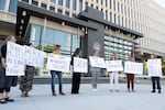 A group of transgender advocates hold signs outside the federal courthouse in Boise on Friday, June 5, 2026.