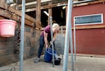 Christine Anderson empties a bucket containing water she used to clean the milking equipment at her milking parlor in McMinnville, Ore., April 18, 2024. Anderson said her CAFO permit prohibits her from dumping it to a drain or her residential septic tank.