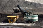 In this April 4, 2013, file photo, a mechanized shovel loads a haul truck with coal at the Spring Creek coal mine near Decker, Mont. The United States is out of the Paris climate agreement on the day after the 2020 presidential election. Experts say the outcome will determine to some degree just how hot and nasty the world will get in the future. The two presidential candidates have stark differences on fighting human-caused climate change.