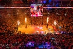 Flames are sprayed from the top of the goal posts during the Portland Fire starting line introduction at the Moda Center in Portland, Ore., on July 9, 2026. Gustafson's corgi, Pancake, has become famous among Portland Fire fans.