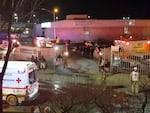Image taken from a video showing ambulances and rescue teams staffers outside an immigration center in Ciudad Juarez, Mexico on Tuesday.