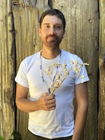 Mark Petrie, a CLUSI tribal member, with the Columbian strain of tobacco. It's considered a sacred and important plant.