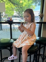 Nearly three-year-old Rosemary enjoys a chopped chocolate bagel from Fairbanks Bread on June 1, 2026.