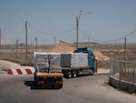 A truck loaded with food on the Israeli side of the border crossing heads back into Gaza. However, the food is sitting for days or weeks before it can be distributed. The U.N. and aid groups say they face a host of problems that include a shortage of trucks and fuel due to the war, as well as criminal gangs that are looting the supplies. 