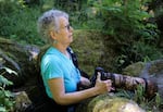 Wildlife photographer, Linda Steider looking for pikas to capture with her camera at Little Beacon Rock, Washington. June 16, 2026
