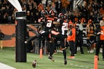 Oregon State's Tyjon Lindsey (1), Trevon Bradford (8), and Trey Lowe (21) celebrate Bradford's touchdown during the second half of the team's NCAA college football game against Utah on Saturday, Oct. 23, 2021, in Corvallis, Ore.