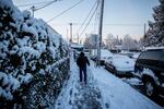 A pedestrian carefully navigates an iced-over sidewalk in Southeast Portland Wednesday, Feb. 21, 2018.