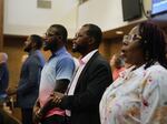 Members of the Haitian community in Springfield, Ohio, from left, Lindsay Aime, James Fleurijean, Viles Dorsainvil, and Rose-Thamar Joseph, stand for worship at Central Christian Church, on Sunday, Sept. 15, 2024. (AP Photo/Jessie Wardarski)