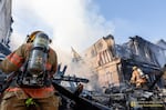 In this image provided by Portland Fire & Rescue, teams work at the scene where a small aircraft crashed into multiple townhouses in Fairview, Ore., August 31, 2024, killing three people.