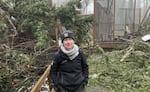 Kit Lacy, bird curator for the Cascades Raptor Center, stands outside two aviaries that took heavy tree and ice damage during the ice storms.