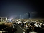 Palestinians carry away sacks of food collected in the middle of the night from a food distribution site run by the Gaza Humanitarian Foundation on June 24, 2025.
