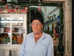 Rimon Himo, 69, a Palestinian resident of the Old City of Jerusalem, stands in front of his shop after being attacked by a mob.