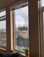 A window damaged on Jan. 31, 2026, when a projectile with a corkscrew tail of smoke smashed into a third-story apartment window at Gray’s Landing, located kitty-corner from the U.S. Immigration and Customs Enforcement building in Portland. The inhabitants of the apartment, a 29-year old woman and her 70-year-old mother, both suffered coughing fits through the night, vomited and one briefly fainted.