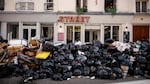 Uncollected garbage is piled up on a street in Paris on Wednesday during an ongoing strike by sanitation workers. Opponents of French President Emmanuel Macron's pension plan are staging strikes and protests as the contested bill heads toward a vote.
