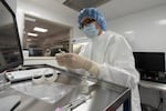 A pharmacist at Mount Sinai Queens hospital in New York labels syringes in a clean room where doses of COVID-19 vaccines will be handled. Gov. Kate Brown laid out preliminary details of Oregon's vaccine strategy on Friday.