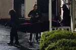 A police officer watches as a body is taken from the Gold Spa massage parlor after a shooting, late Tuesday, March 16, 2021, in Atlanta. Shootings at two massage parlors in Atlanta and one in the suburbs left multiple people dead, many of them women of Asian descent, authorities said. A 21-year-old man suspected in the shootings was taken into custody in southwest Georgia hours later after a manhunt, police said.