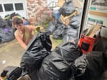 Tristian Williams helps remove clutter from the home of someone with hoarding disorder. The homeowner decided to ask for help with the clean-out after attending a course and support group offered by his father' nonprofit, Fight the Blight.