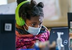 Jae’Lyia, 9, concentrates as she works on a math game in class.