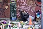 An unidentified woman is pictured at a memorial at Portland's Normandale Park for shooting victim June Knightly.