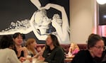 Guests socialize over food and drink in an event space at Revolution Hall in Portland, Ore., March 5, 2026. The venue hosted OPB's "Think Out Loud" for a live taping of a conversation about the complexities of modern dating.