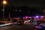 Police officers search a crime scene on Interstate 84 in Portland, Ore., Tuesday, Feb. 5, 2019. Major police activity closed a portion of the highway in both directions.