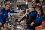 From left to right: Astronauts Reid Wiseman, Artemis II commander, Jeremy Hansen, Artemis II mission specialist, and Christina Koch, Artemis II mission specialist, pose for a portrait inside the Orion spacecraft mockup.